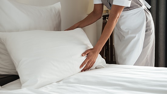 Housekeeper at hotel bed
